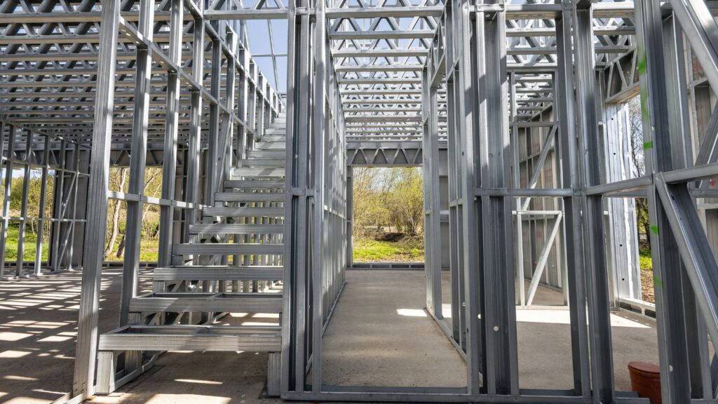 Steel framing for small prefab sustainable housing under construction, showcasing modular building components and eco-friendly design.