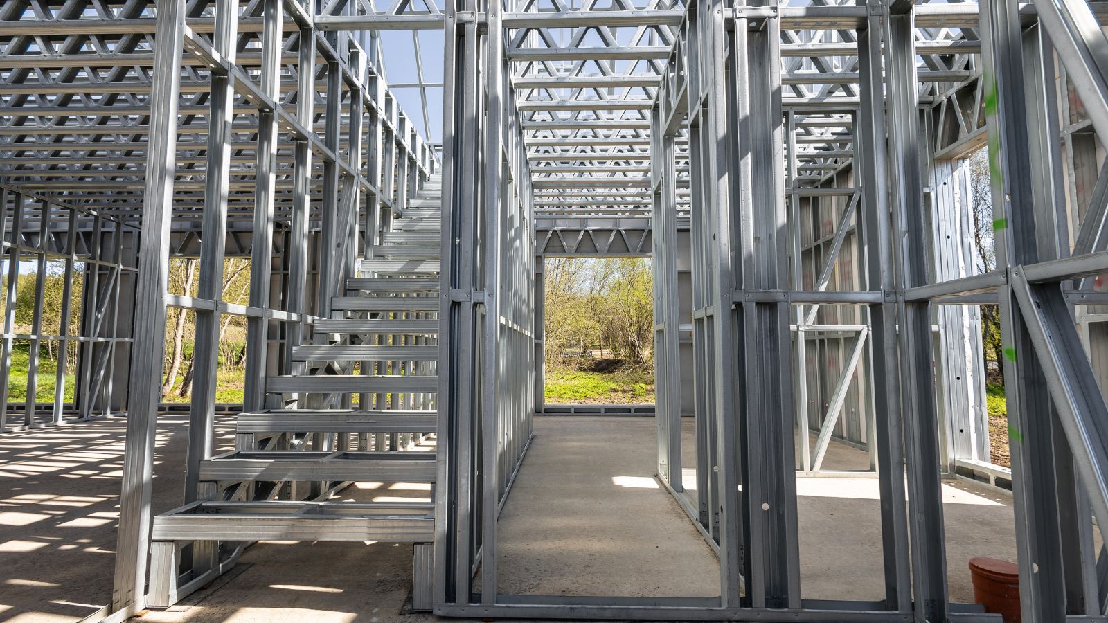 Steel framing for small prefab sustainable housing under construction, showcasing modular building components and eco-friendly design.