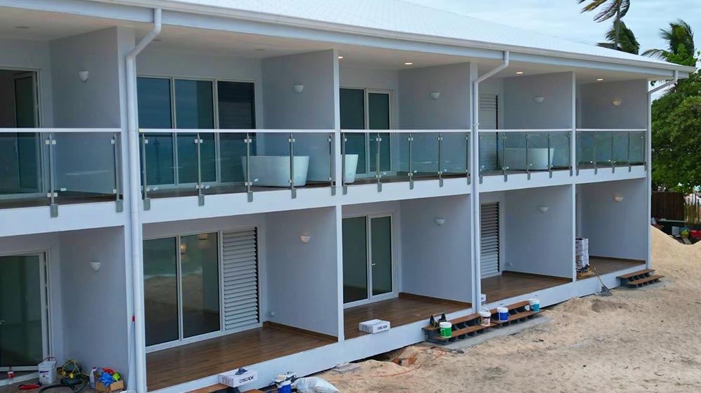 Contemporary hotel with light steel frame construction, spacious balconies, and modern design in a tropical setting in Fiji.